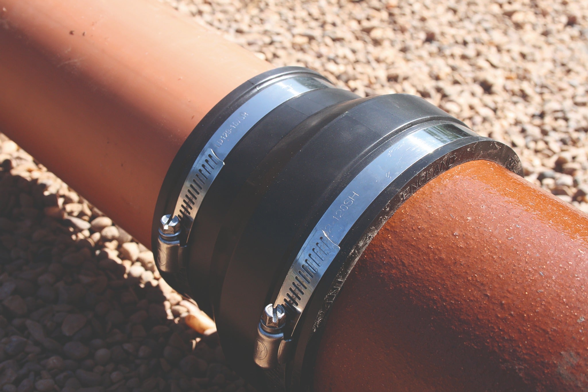 Fernco EPDM plumbing adaptor coupling installed between pipes