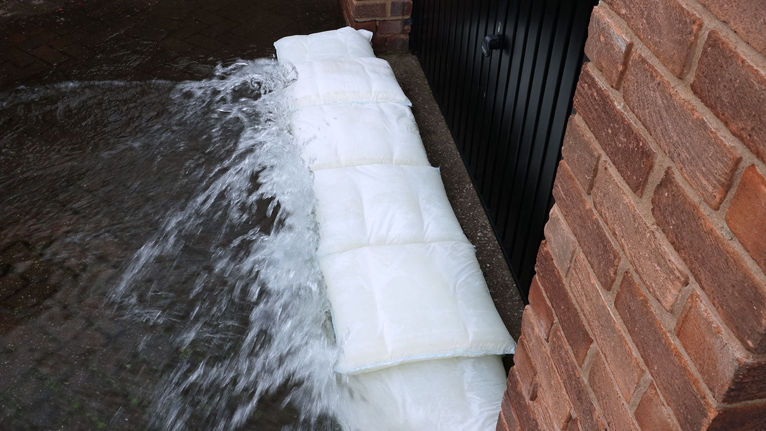 Fernco Floodbags defending a garage from floodwater